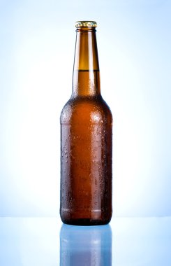 Full brown bottle with condensation on a blue background clipart