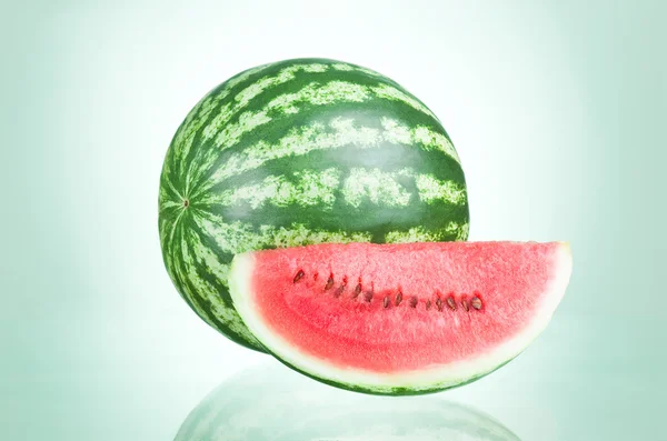 Ripe Watermelon and Slice isolated on a green background — Stock Photo, Image