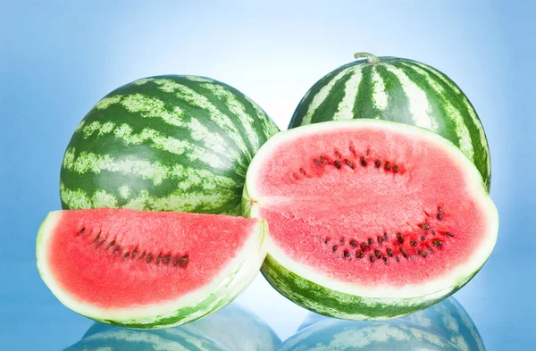 Two Whole watermelon, half and Slice on a blue background — Stock Photo, Image