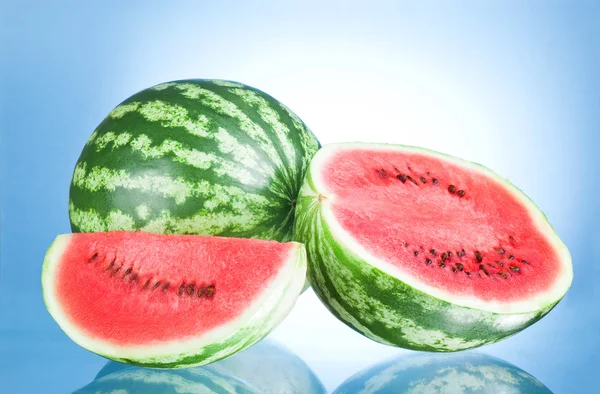 Whole watermelon, half and Slice on a blue background — Stock Photo, Image
