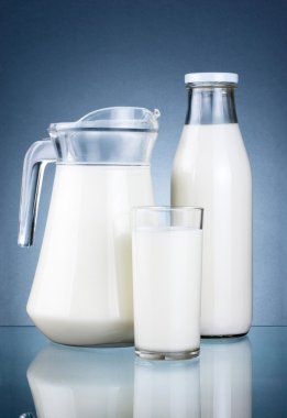 Full Jug, Bottle of fresh milk and glass isolated on dark grey b clipart