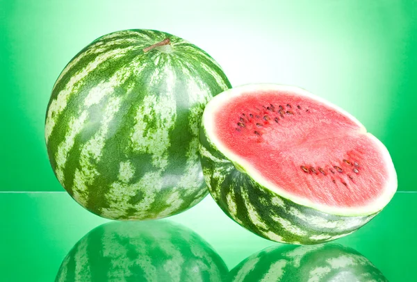 Watermelon and half on a green background — Stock Photo, Image