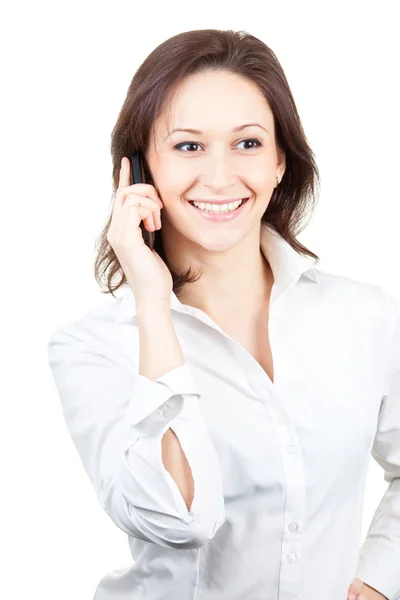 Ευτυχής όμορφη γυναίκα σε ένα λευκό πουκάμισο με απομονωμένες o κινητό τηλέφωνο — Φωτογραφία Αρχείου