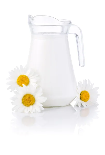 Jug fresh milk and three chamomile flowers isolated on white bac — Stock Photo, Image