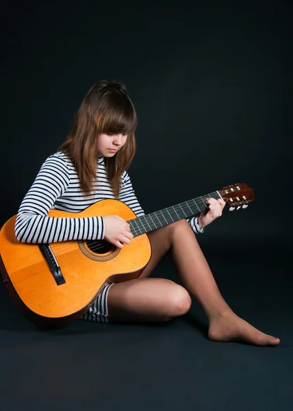 stock image Girl with a guitar on a black background