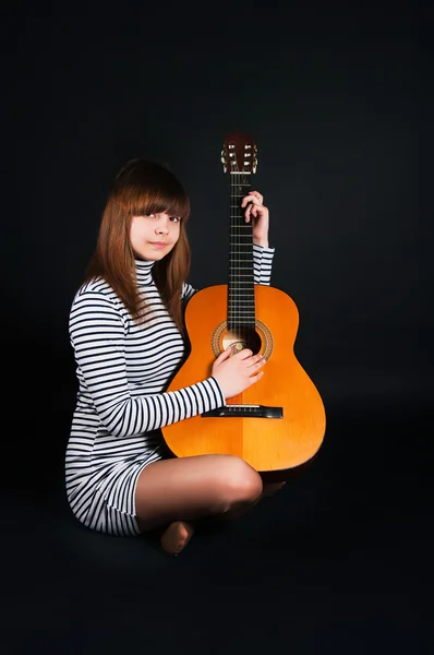 stock image Girl with a guitar on a black background