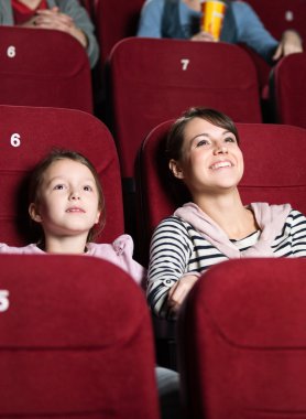 Mother and daughter at the cinema clipart