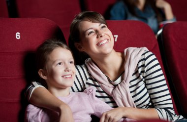 Mother with daughter in the movie clipart