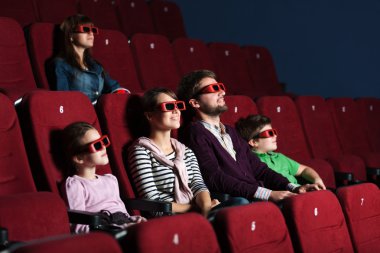 Young family in the movie theater clipart
