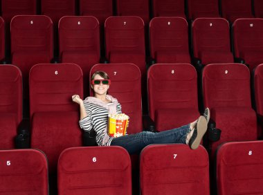 Smiling woman in 3D movie theater clipart