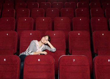 Napping woman at the cinema clipart