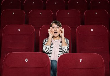 Young woman afraid of the movie clipart