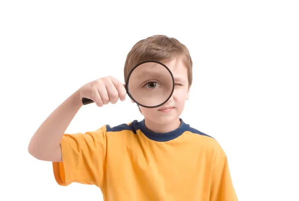 Young boy with magnifying glass — Stock Photo, Image