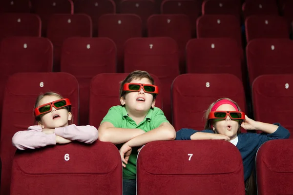 Удивленные дети в кинотеатре — стоковое фото