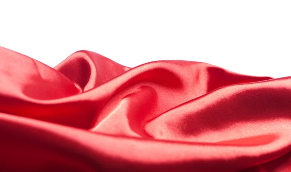 Red silk or satin fabric over white background — Stock Photo, Image
