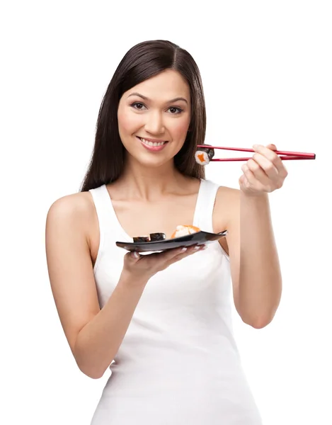 Mooi meisje houden sushi met een stokjes — Stockfoto