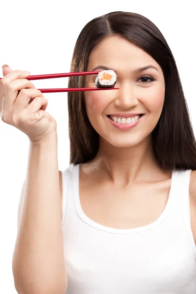 Smiling woman holding sushi roll with a chopsticks — Stock Photo, Image