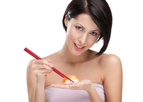 Attractive woman holding sushi with a chopsticks — Stock Photo, Image