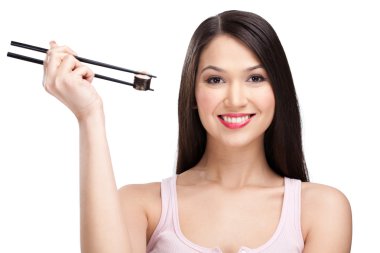 Smiling woman holding sushi roll with a chopsticks clipart