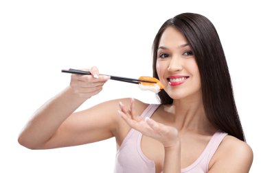 Beautiful woman eating sushi with a chopsticks clipart