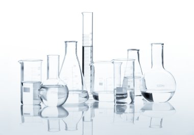 Group of classic laboratory flasks with a clear liquid clipart