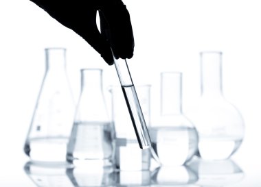 Set of laboratory flasks with a clear liquid clipart