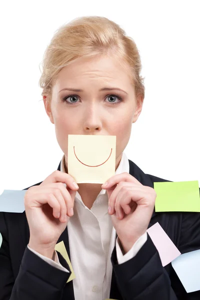 Businesswoman holding a yellow sticker in front of her face — Stock Photo, Image