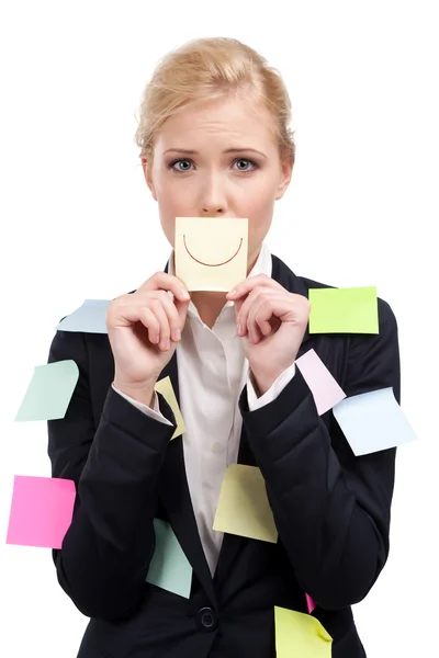 Attractive business woman holding a yellow sticker in front of her face — Stock Photo, Image
