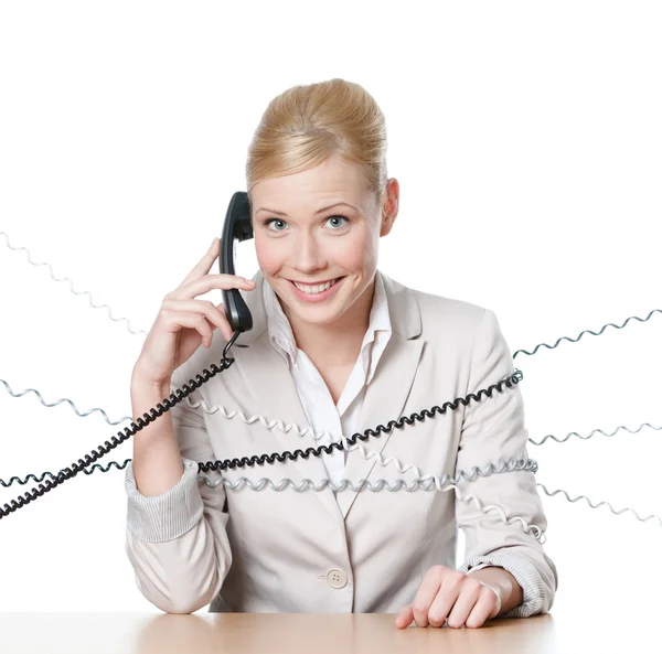 Young business woman tied with phone wire — Stock Photo, Image