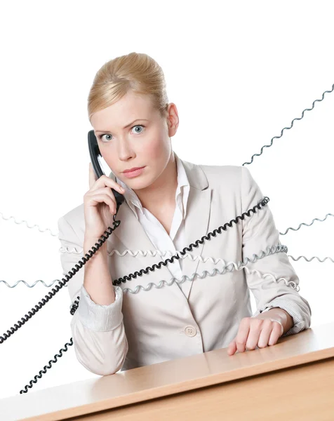 Young business woman tied with phone cable — Stock Photo, Image