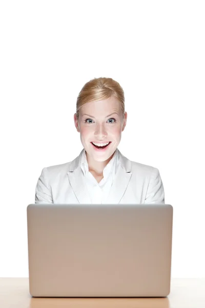 stock image Happy young business woman sitting at a office desk with laptop