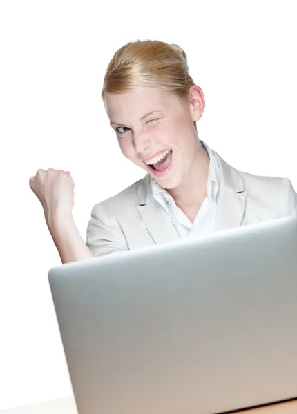 Happy young businesswoman sitting at a table with laptop — Stock Photo, Image