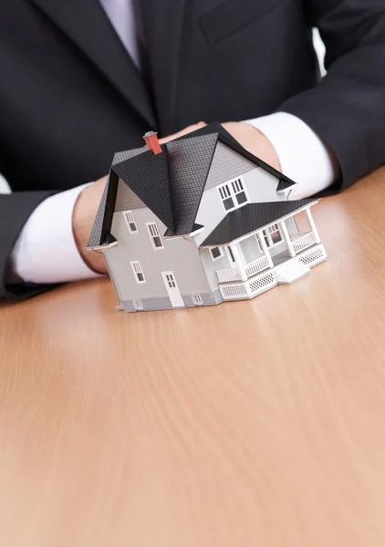 Businessman hands behind house model — Stock Photo, Image