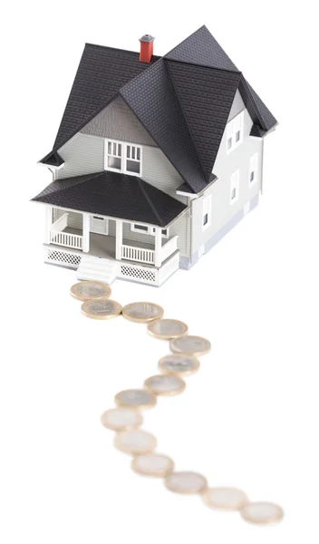Coins in front of household model, isolated — Stock Photo, Image