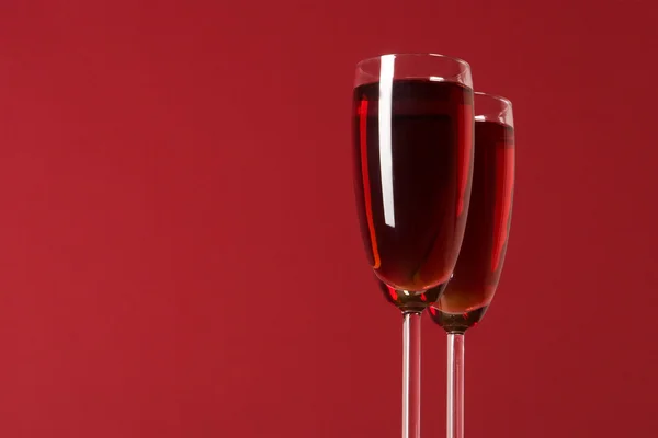 stock image Two wineglasses with wine on the red background