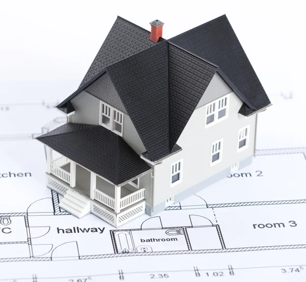 Construction plan with house architectural model Stock Picture