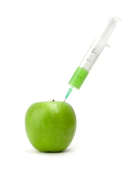 Green apple with syringe inserted — Stock Photo, Image