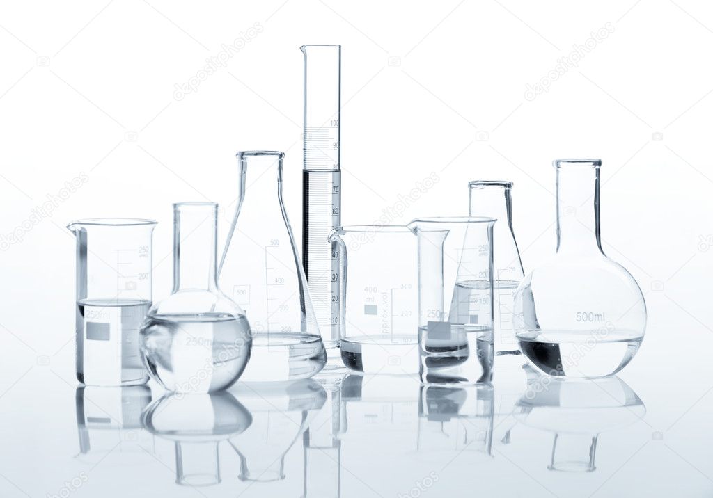 Group of classic laboratory flasks with a clear liquid