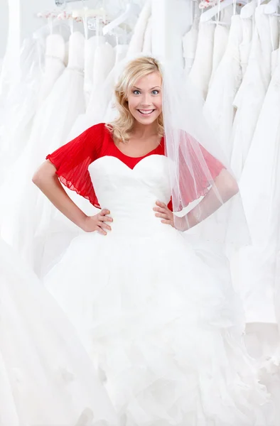 Trying a fascinating wedding gown on — Stock Photo, Image