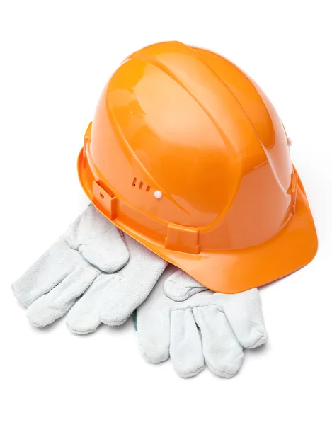 Оранжевая каска на белых перчатках — стоковое фото