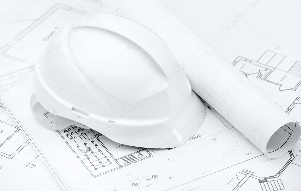 White hard hat on working drawings