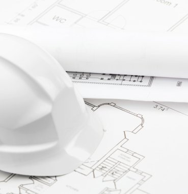 White hard hat on several working drawings clipart