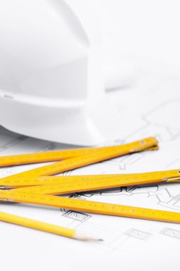 White hard hat near working tools, close up clipart