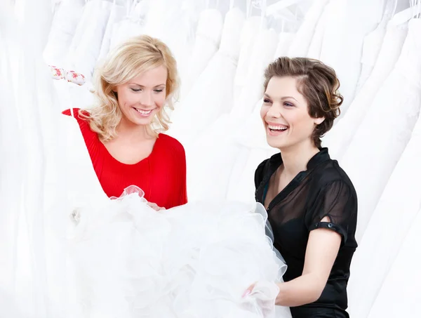 Designer and the client have a good look at the dress — Stock Photo, Image