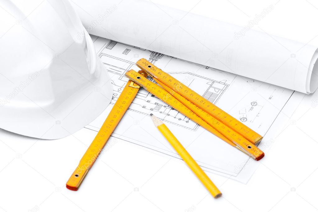 White hard hat, foot ruler and pencil on the druft, isolated on white