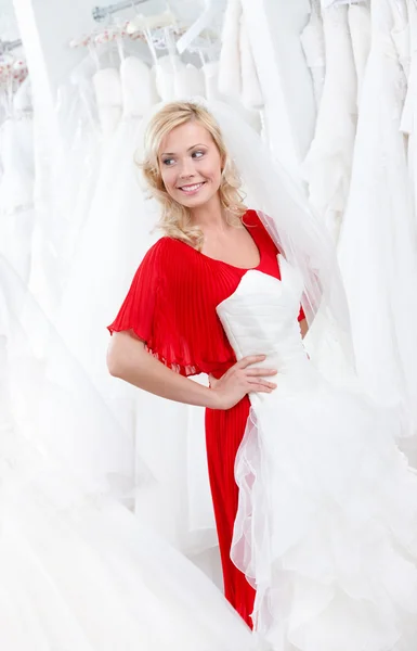 Putting a wedding gown on — Stock Photo, Image