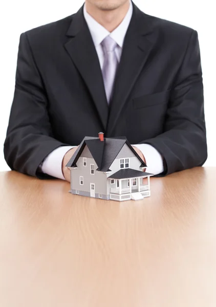 Business man hands behind house model — Stock Photo, Image