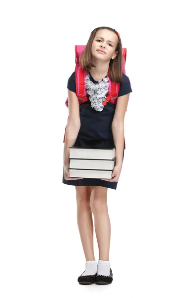 Школярка з портфелем і купою книг — стокове фото