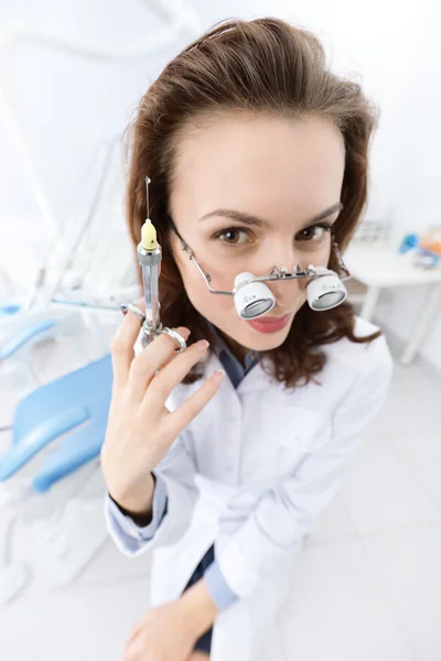 Trying on medical spectacles and keeping syringe — Stock Photo, Image