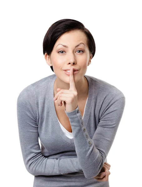 Mooie vrouw toont stilte gebaar aan te raken haar lippen — Stockfoto